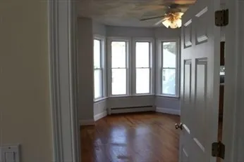 a view of room with window and hardwood floor