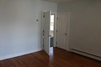 an empty room with wooden floor