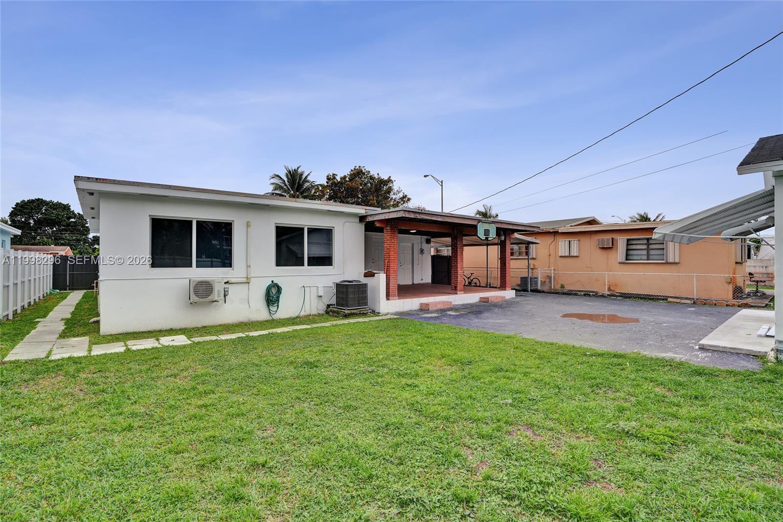 877 West 33rd Street Hialeah, FL 33012 - Photo 16 of 59 a front view of house with yard and seating area