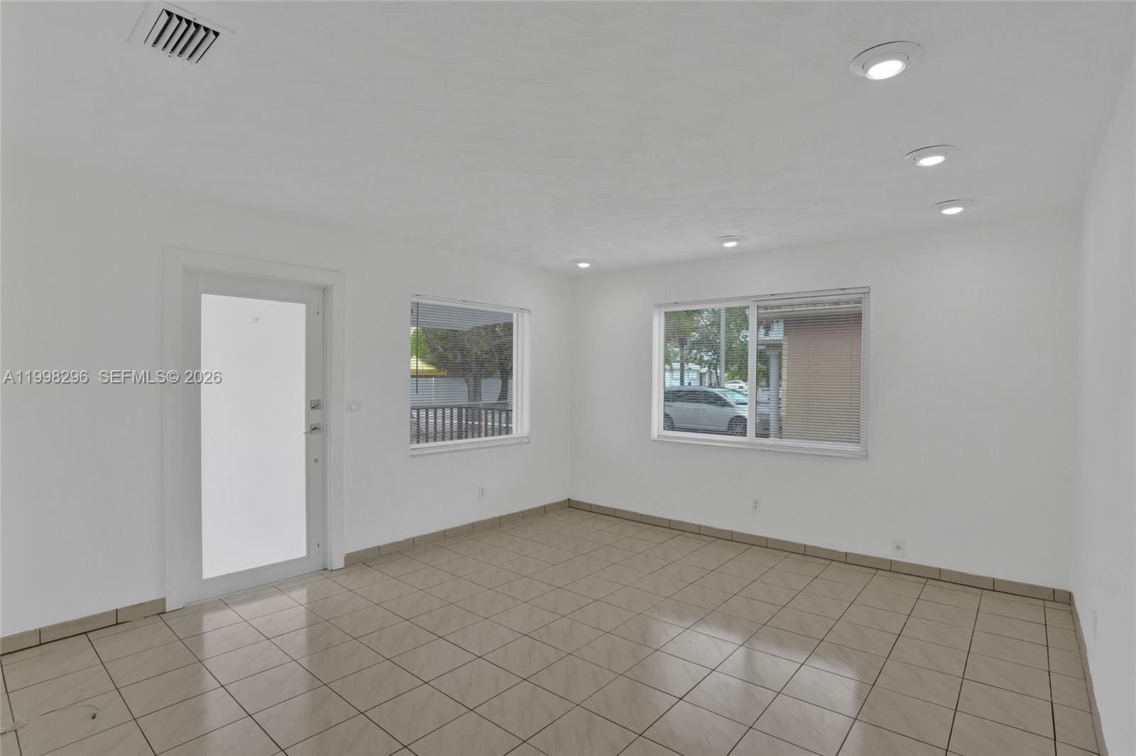 877 West 33rd Street Hialeah, FL 33012 - Photo 19 of 59 an empty room with windows