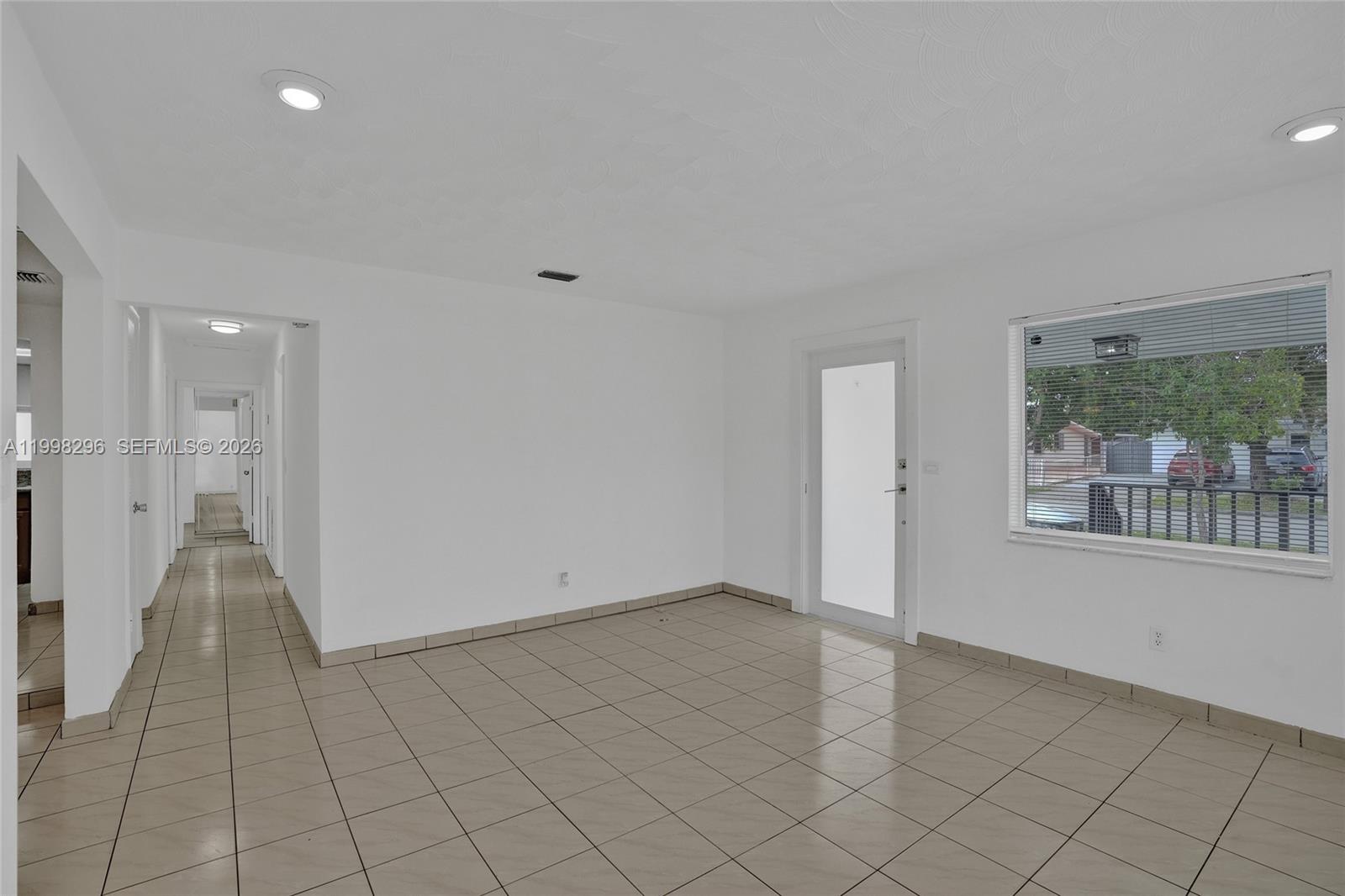 877 West 33rd Street Hialeah, FL 33012 - Photo 21 of 59 wooden floor in an empty room with a window