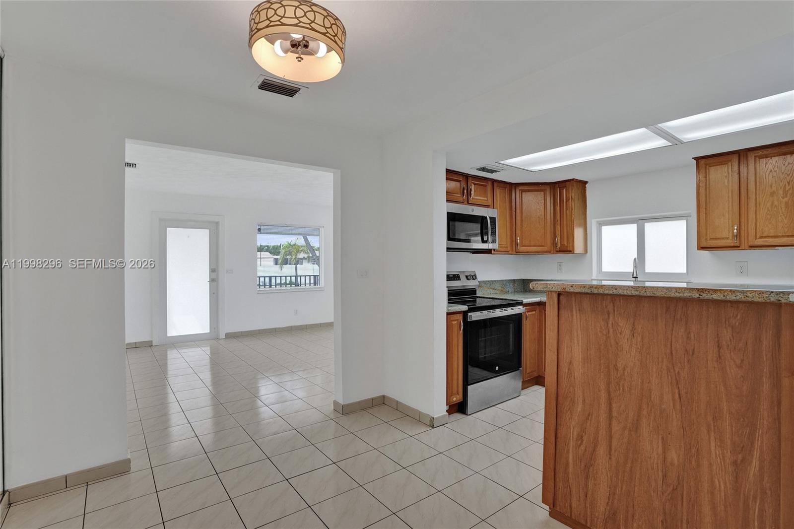 877 West 33rd Street Hialeah, FL 33012 - Photo 23 of 59 a view of a kitchen with an oven
