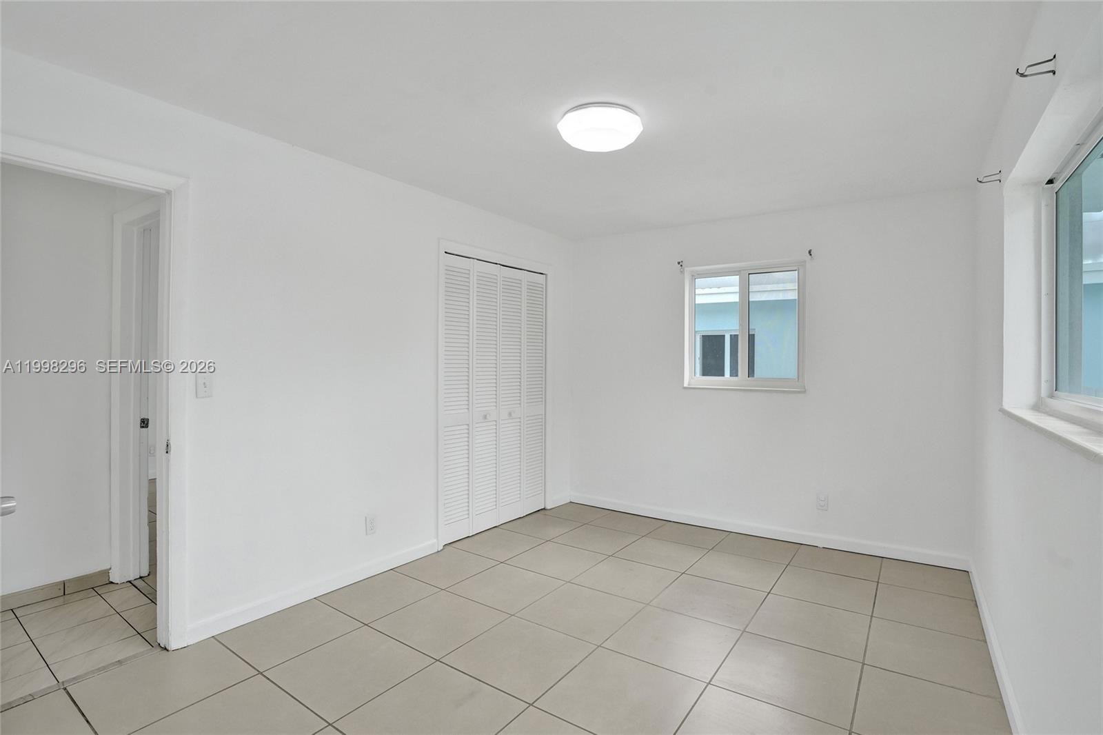877 West 33rd Street Hialeah, FL 33012 - Photo 34 of 59 a view of an empty room with a window