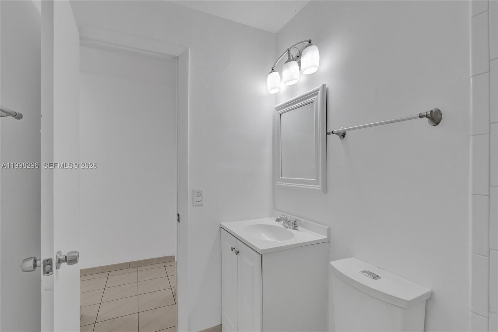 877 West 33rd Street Hialeah, FL 33012 - Photo 37 of 59 a bathroom with a sink a light fixture and a mirror