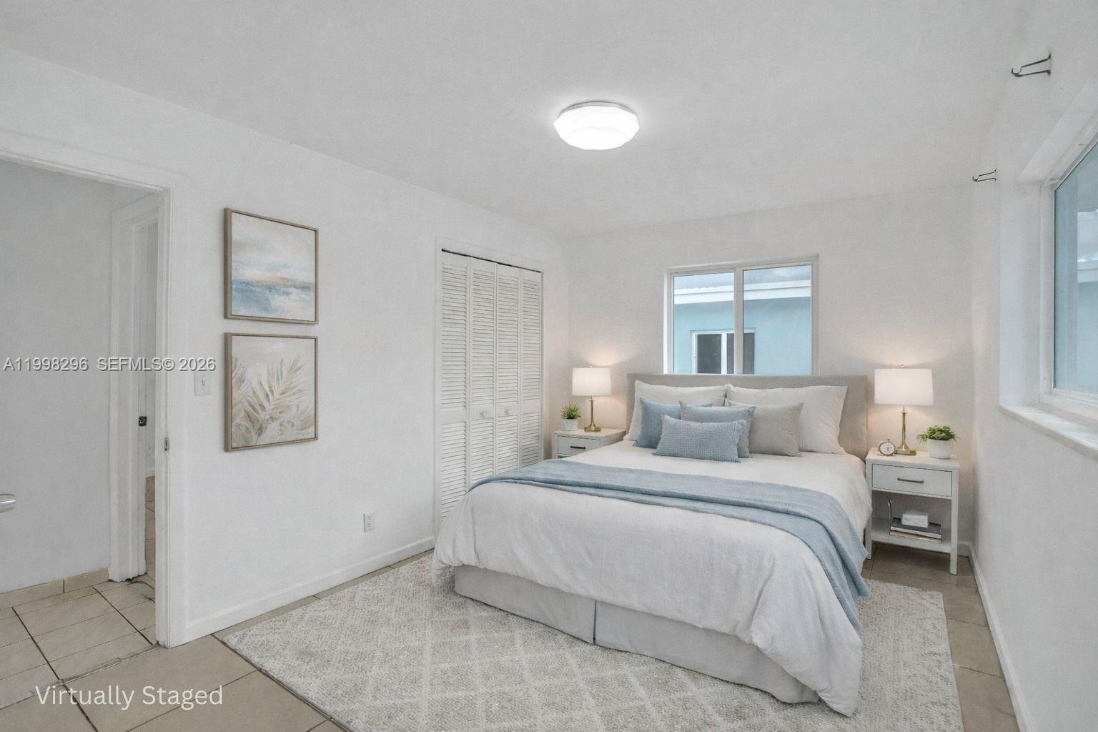 877 West 33rd Street Hialeah, FL 33012 - Photo 4 of 59 a bedroom with a bed and a window