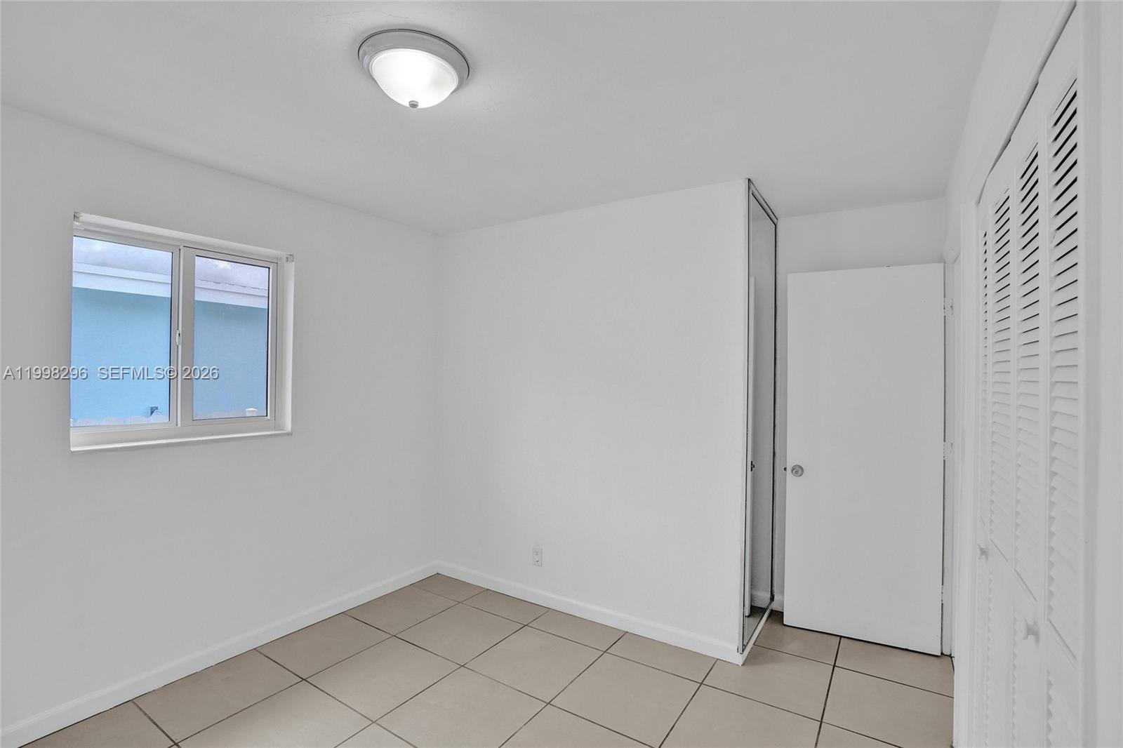 877 West 33rd Street Hialeah, FL 33012 - Photo 41 of 59 a view of an empty room with a window