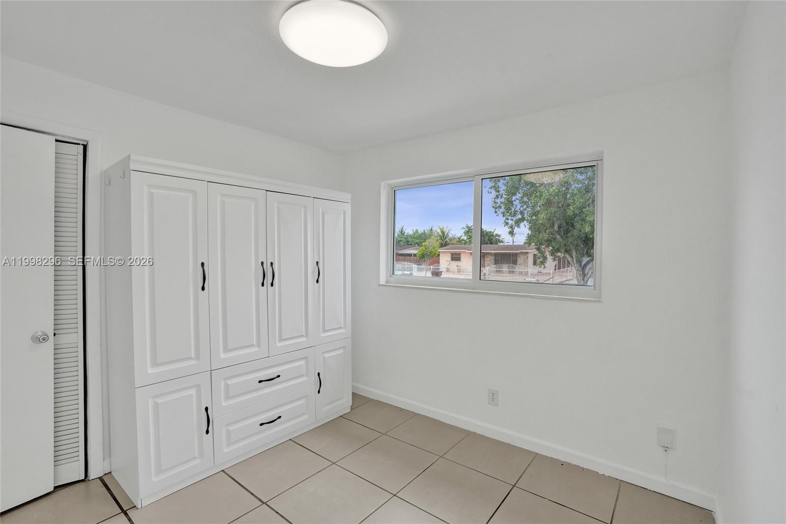 877 West 33rd Street Hialeah, FL 33012 - Photo 47 of 59 a view of room with window and cabinet