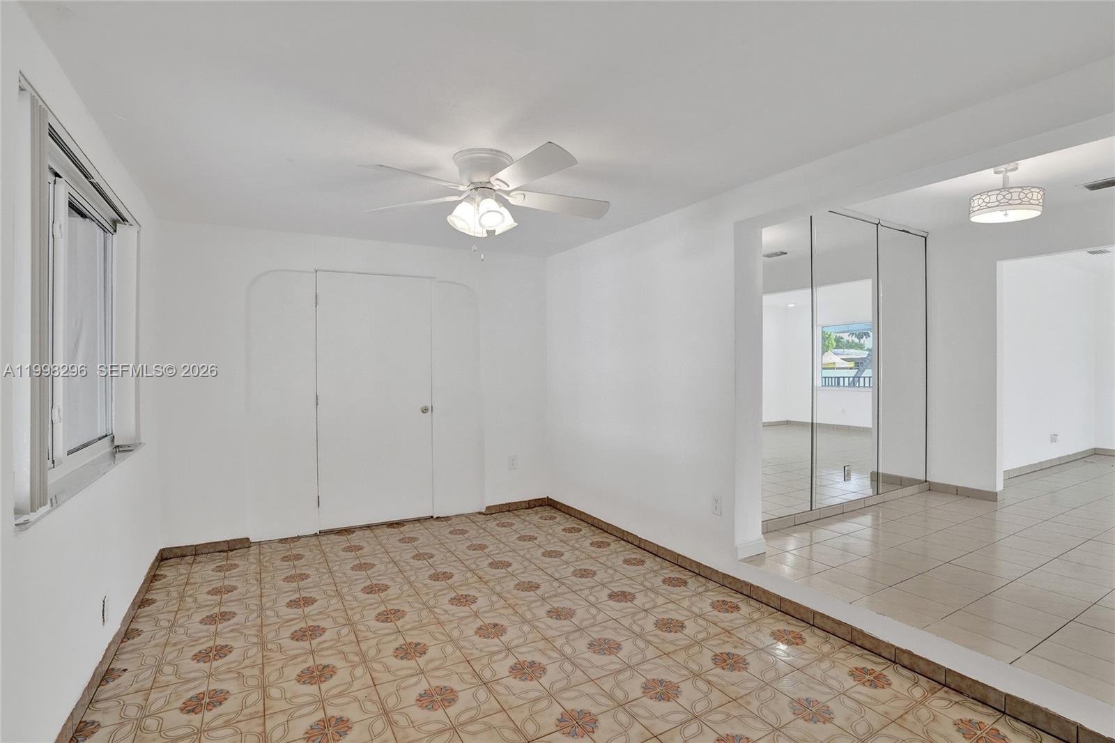 877 West 33rd Street Hialeah, FL 33012 - Photo 54 of 59 wooden floor in an empty room with a window
