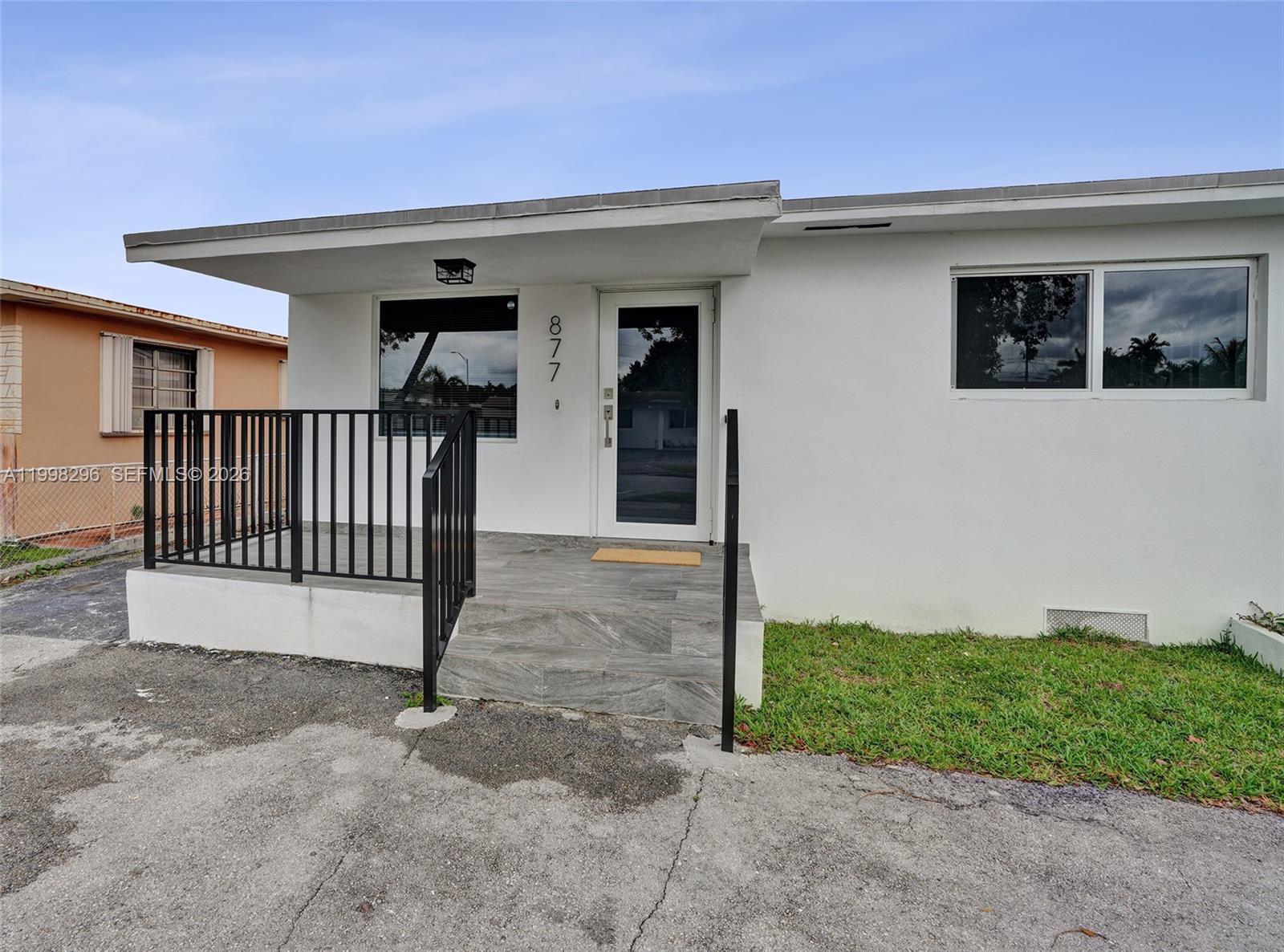 877 West 33rd Street Hialeah, FL 33012 - Photo 56 of 59 a view of a house with a yard and garage