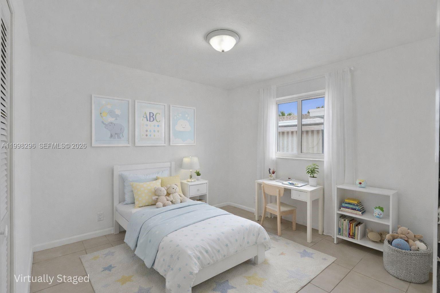 877 West 33rd Street Hialeah, FL 33012 - Photo 7 of 59 a bedroom with a bed a table and chair