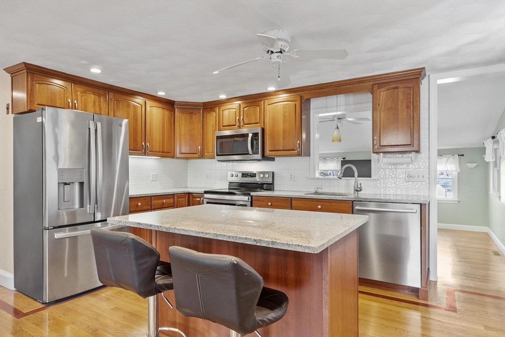 97 Hartwell Road Bedford, MA 01730 - Photo 2 of 42 a kitchen with stainless steel appliances granite countertop a refrigerator a sink a stove and a microwave