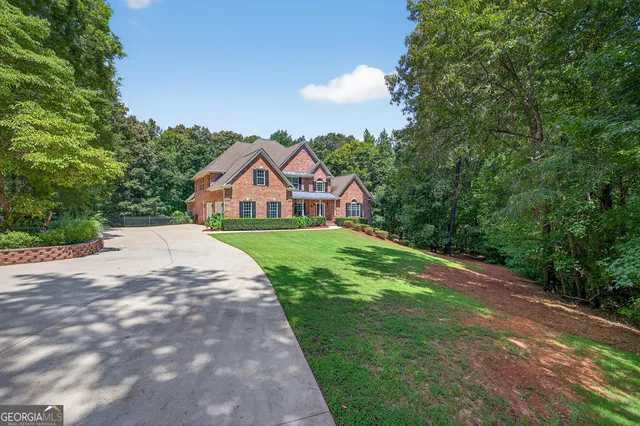 a view of a house with a yard and garage