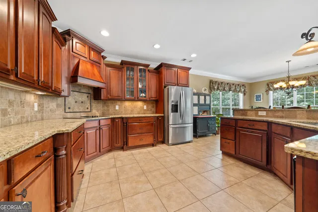a view of a dining room with furniture a chandelier and kitchen view