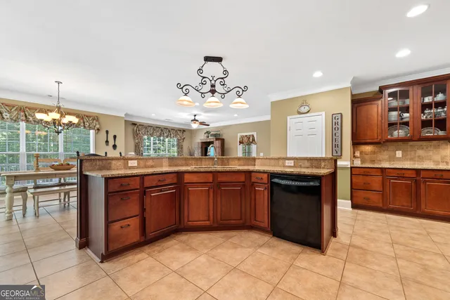 a dining room with furniture a rug and a chandelier