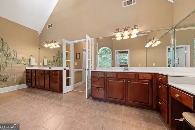 a kitchen with stainless steel appliances granite countertop white cabinets and a sink