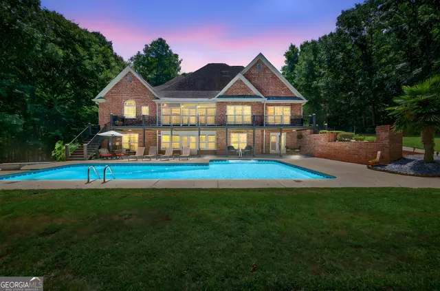 a view of yard with swimming pool and green space