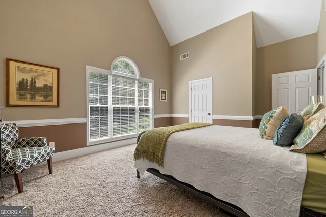 a living room with furniture and a floor to ceiling window