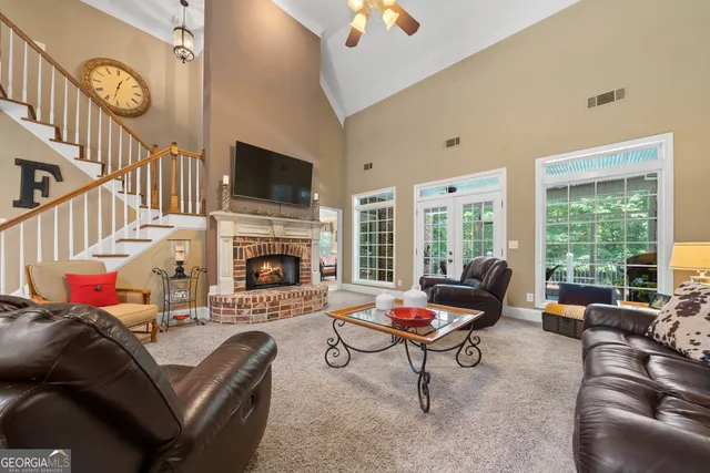 a kitchen with stainless steel appliances wooden cabinets granite counter tops and chairs