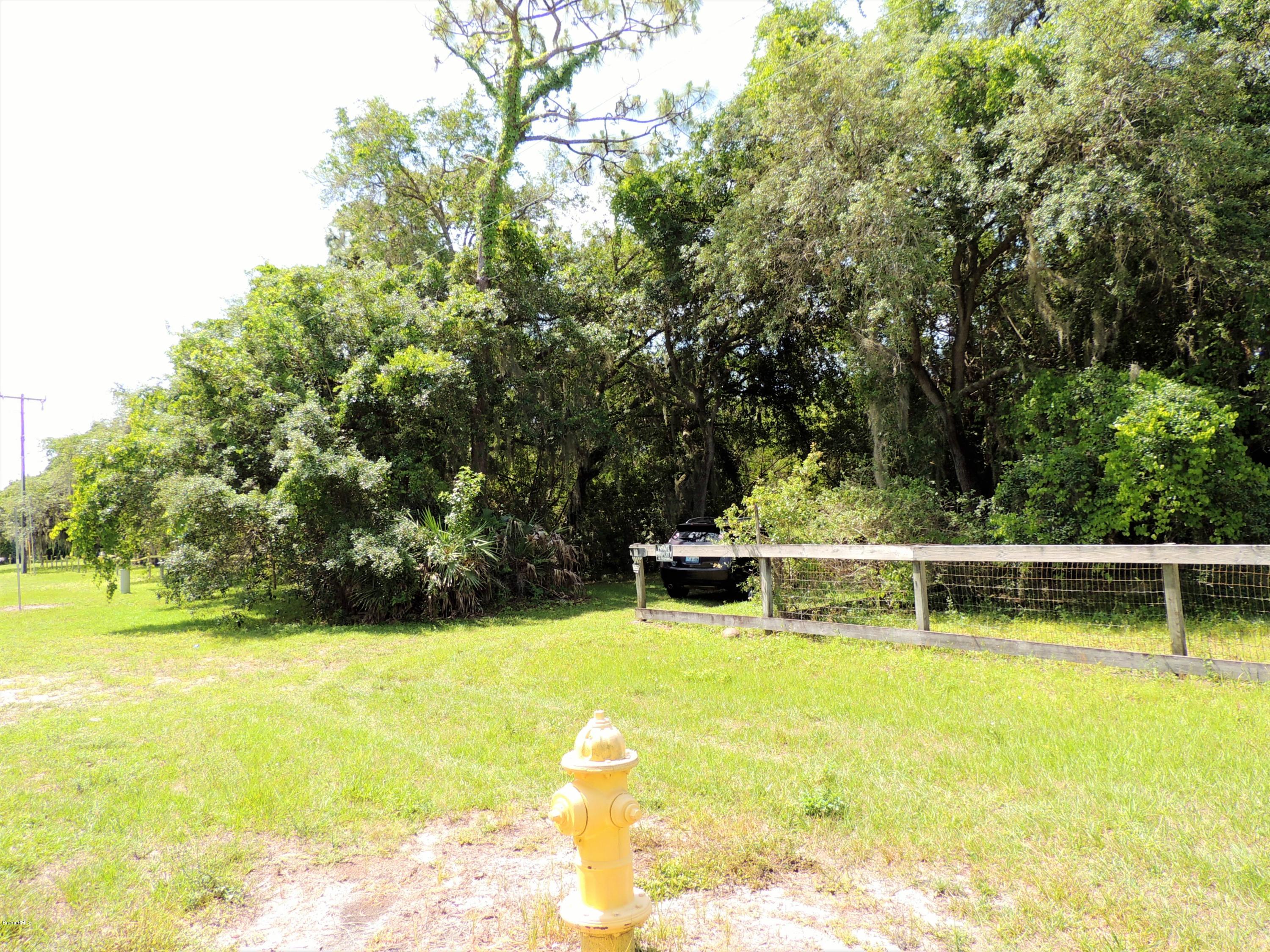 3570 Turtle Mound Road Melbourne, FL 32934 - Photo 17 of 19 a view of a swimming pool with a table and chairs in the patio