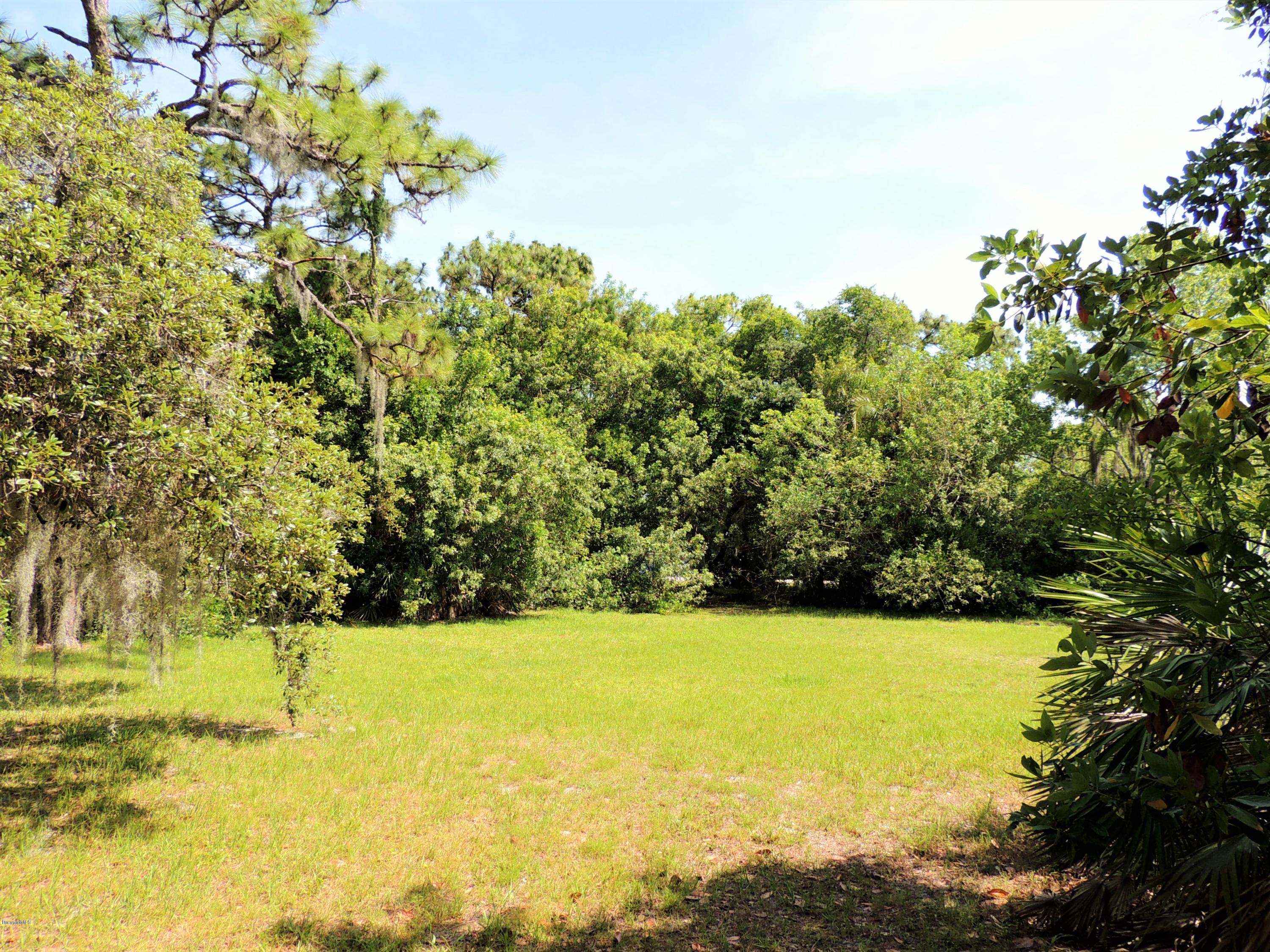 3570 Turtle Mound Road Melbourne, FL 32934 - Photo 9 of 19 a view of yard with swimming pool and green space