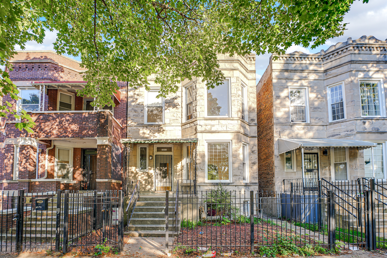 6045 South Peoria Street Chicago, IL 60621 - Photo 2 of 25 a front view of a house with a garden