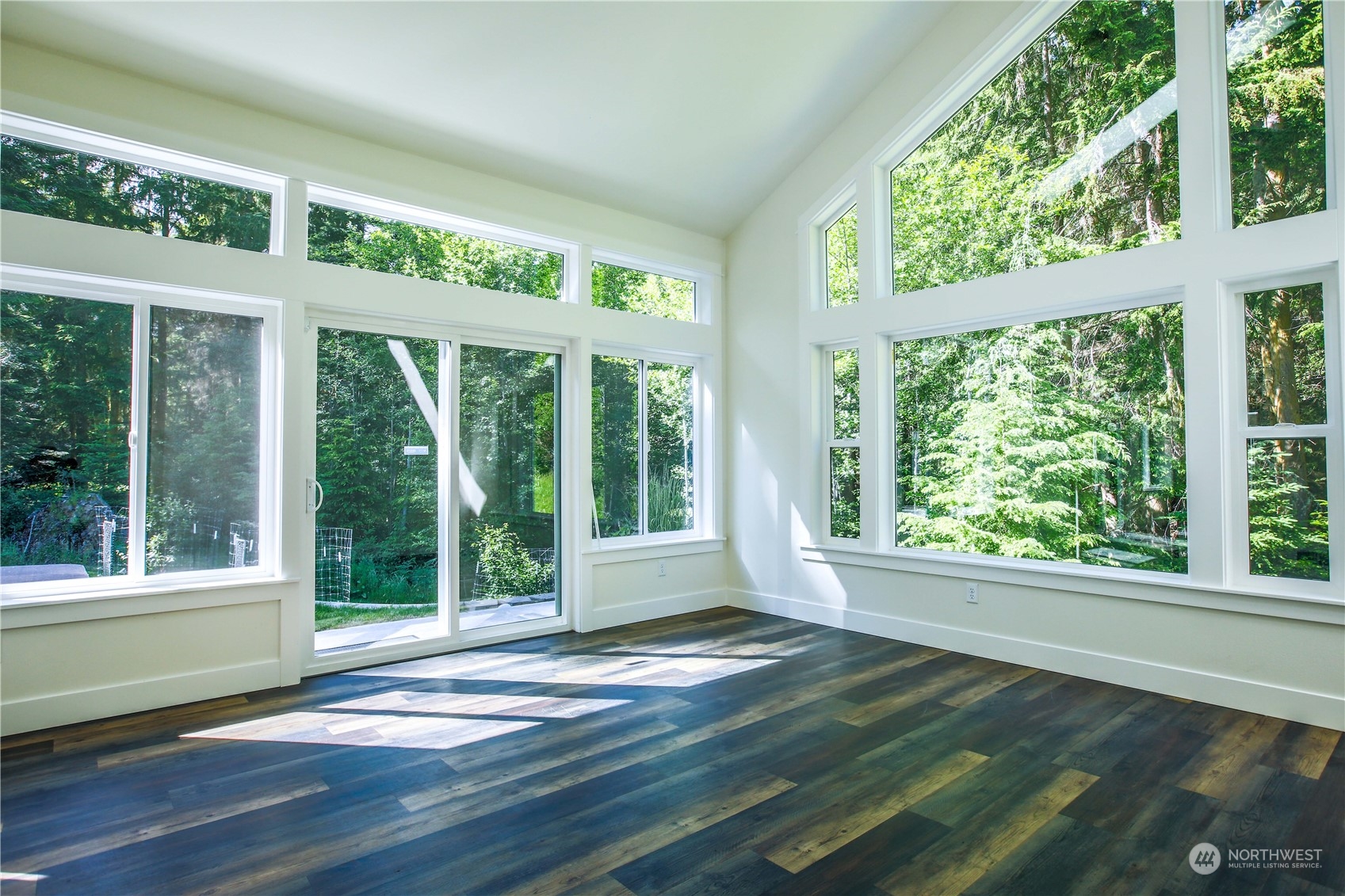 3867 East Harbor Road Langley, WA 98260 - Photo 11 of 39 a view of an empty room with wooden floor and a window