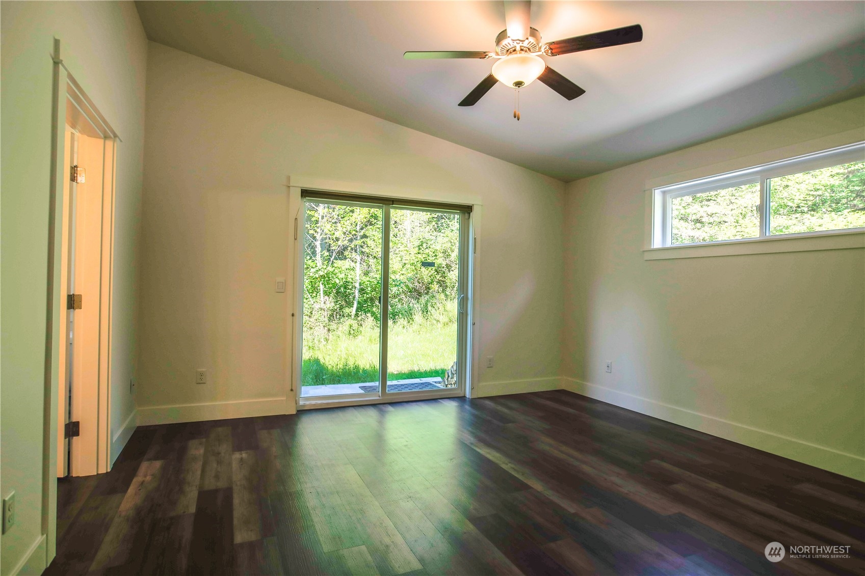 3867 East Harbor Road Langley, WA 98260 - Photo 12 of 39 a view of empty room with wooden floor and fan
