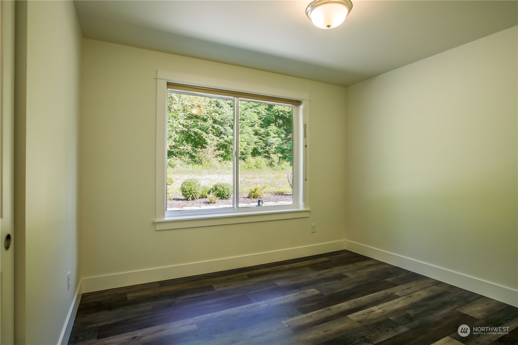 3867 East Harbor Road Langley, WA 98260 - Photo 15 of 39 a view of a room with wooden floor and windows