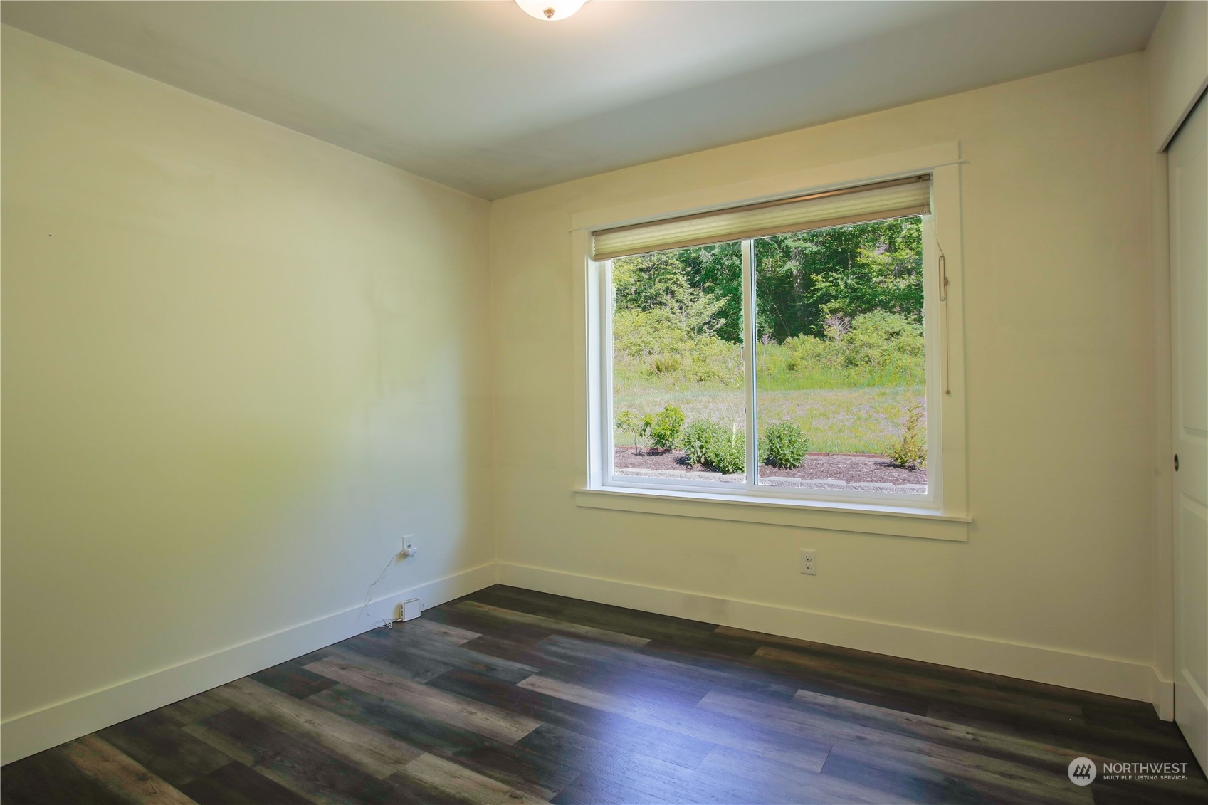 3867 East Harbor Road Langley, WA 98260 - Photo 17 of 39 an empty room with wooden floor and a window
