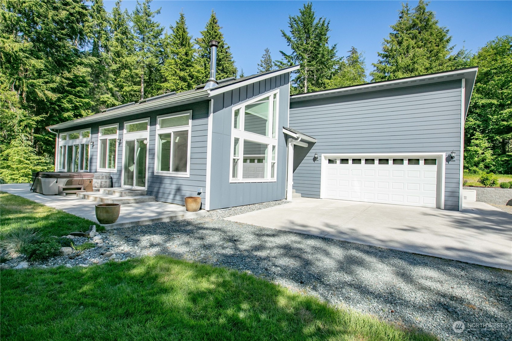 3867 East Harbor Road Langley, WA 98260 - Photo 19 of 39 a front view of a house with a yard and outdoor seating