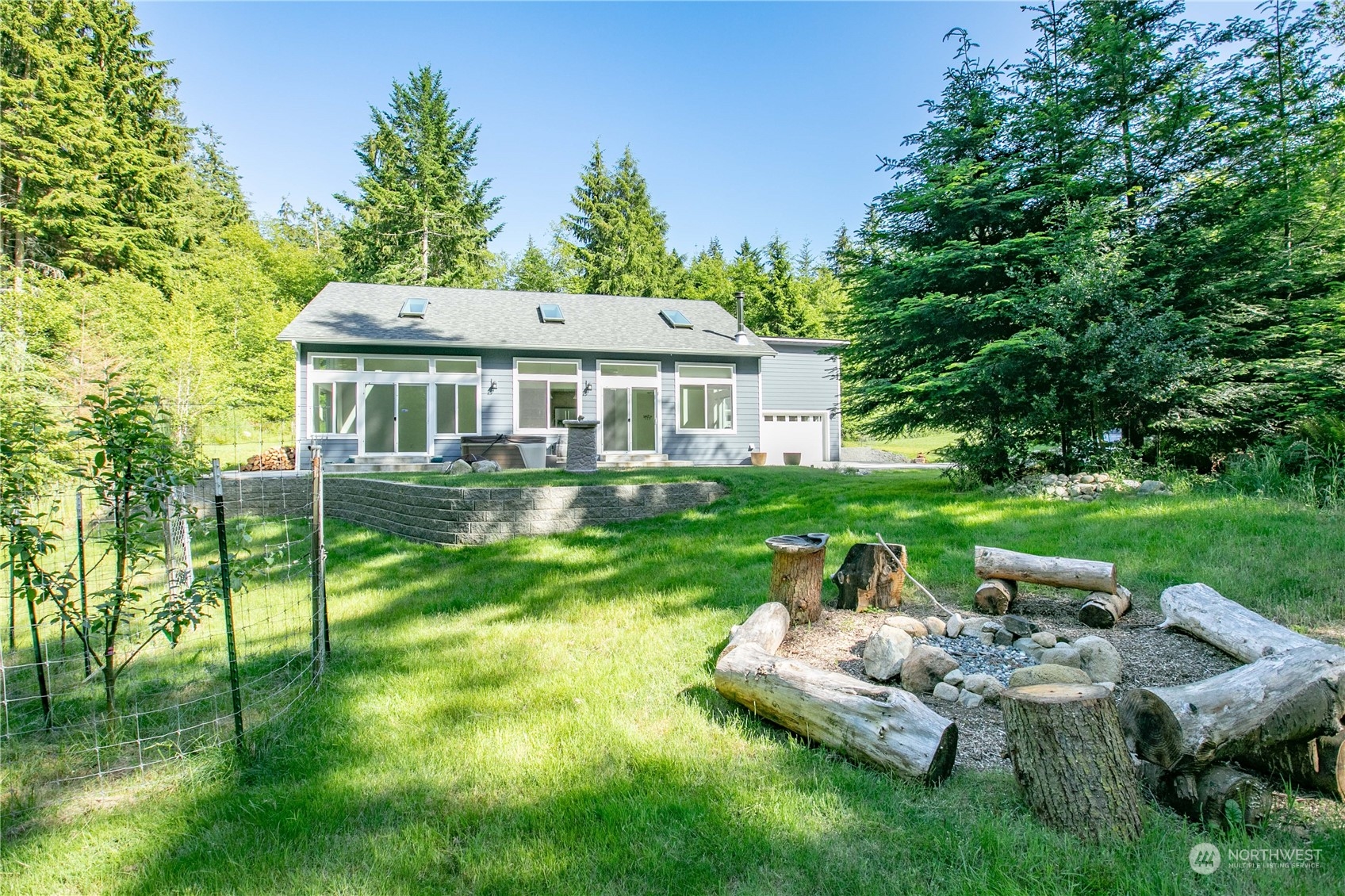 3867 East Harbor Road Langley, WA 98260 - Photo 20 of 39 a view of a house with a backyard and a patio