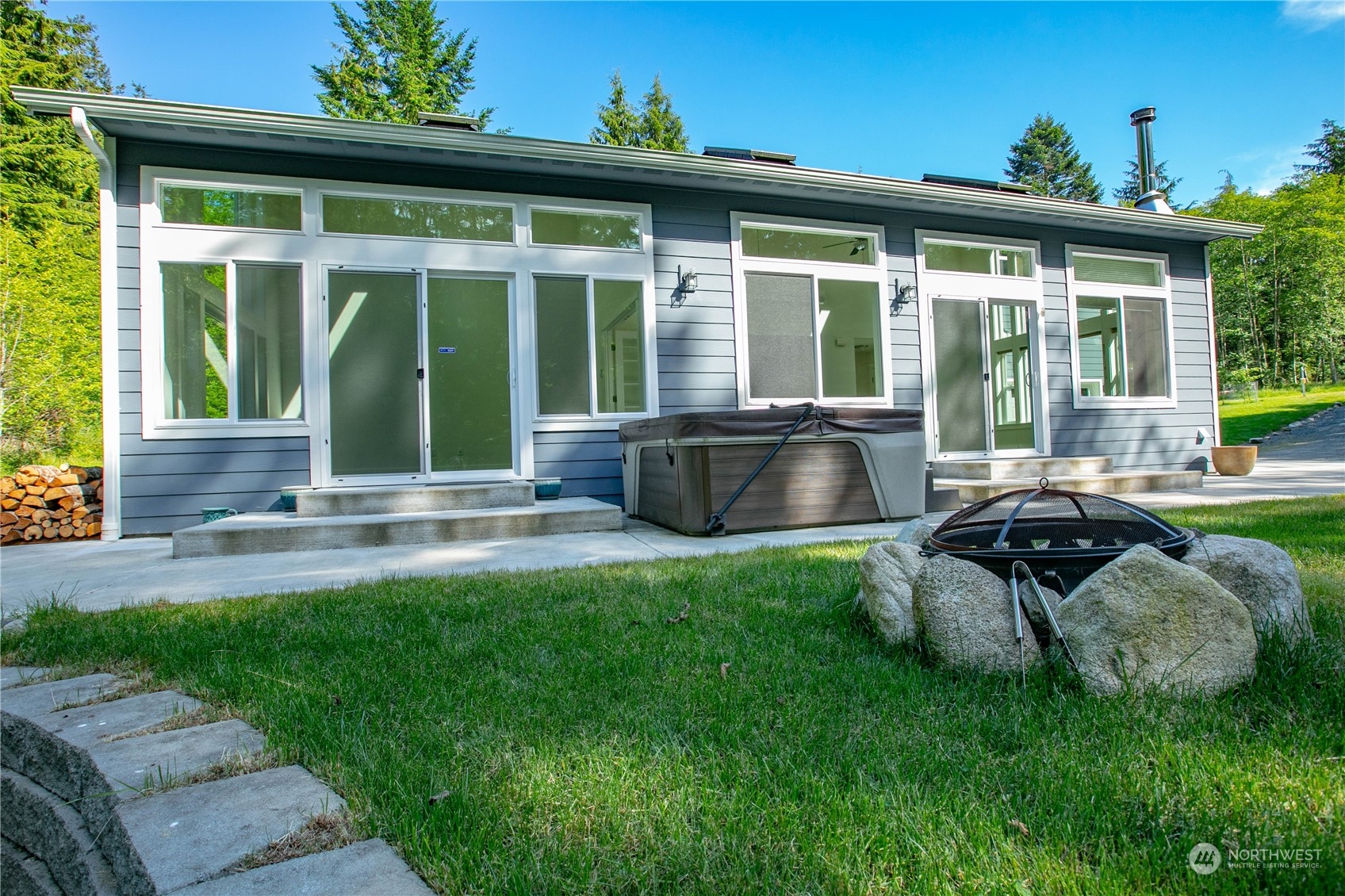 3867 East Harbor Road Langley, WA 98260 - Photo 21 of 39 a view of a house with backyard sitting area and garden