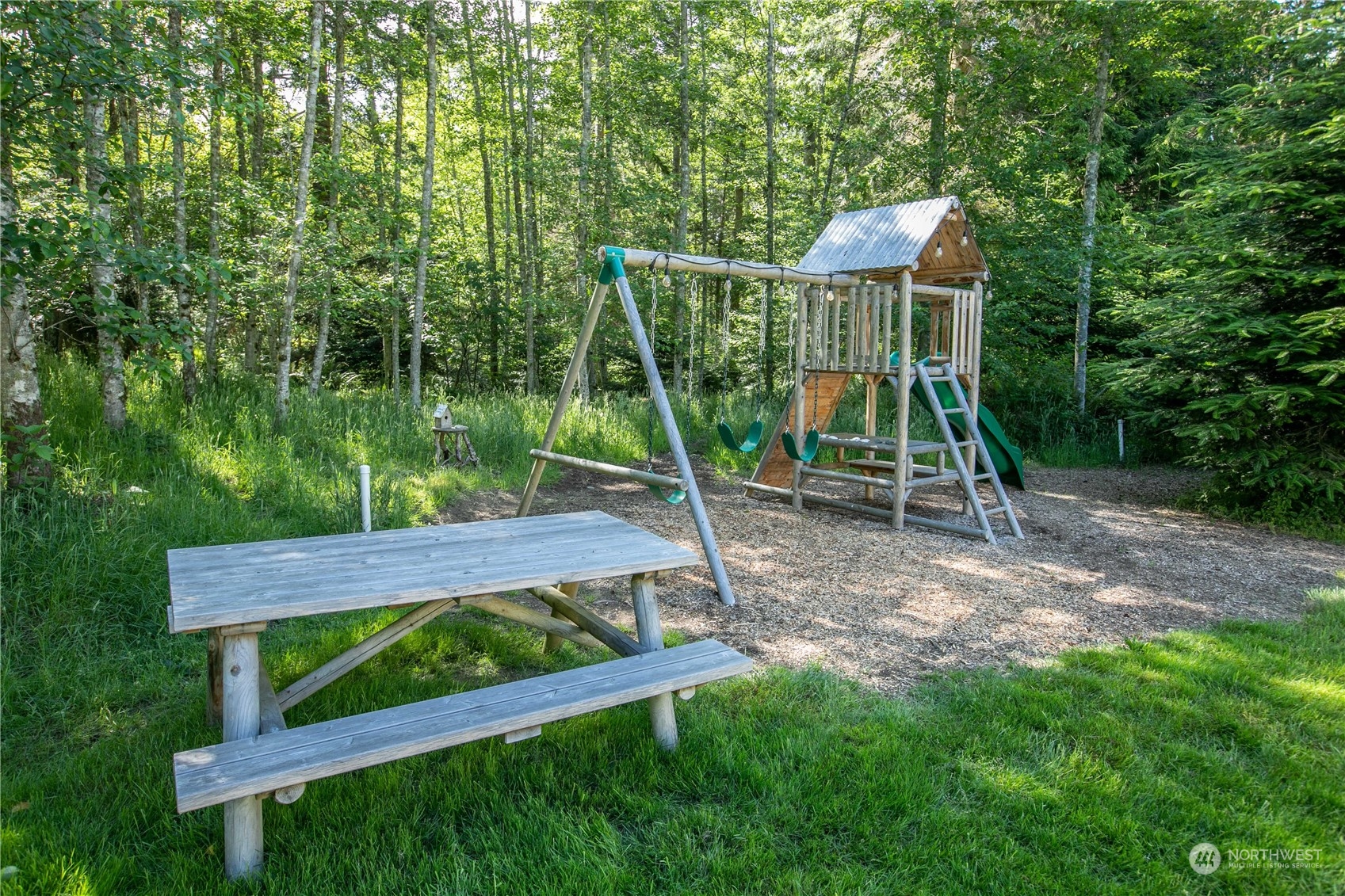 3867 East Harbor Road Langley, WA 98260 - Photo 23 of 39 a view of a wooden deck and a backyard
