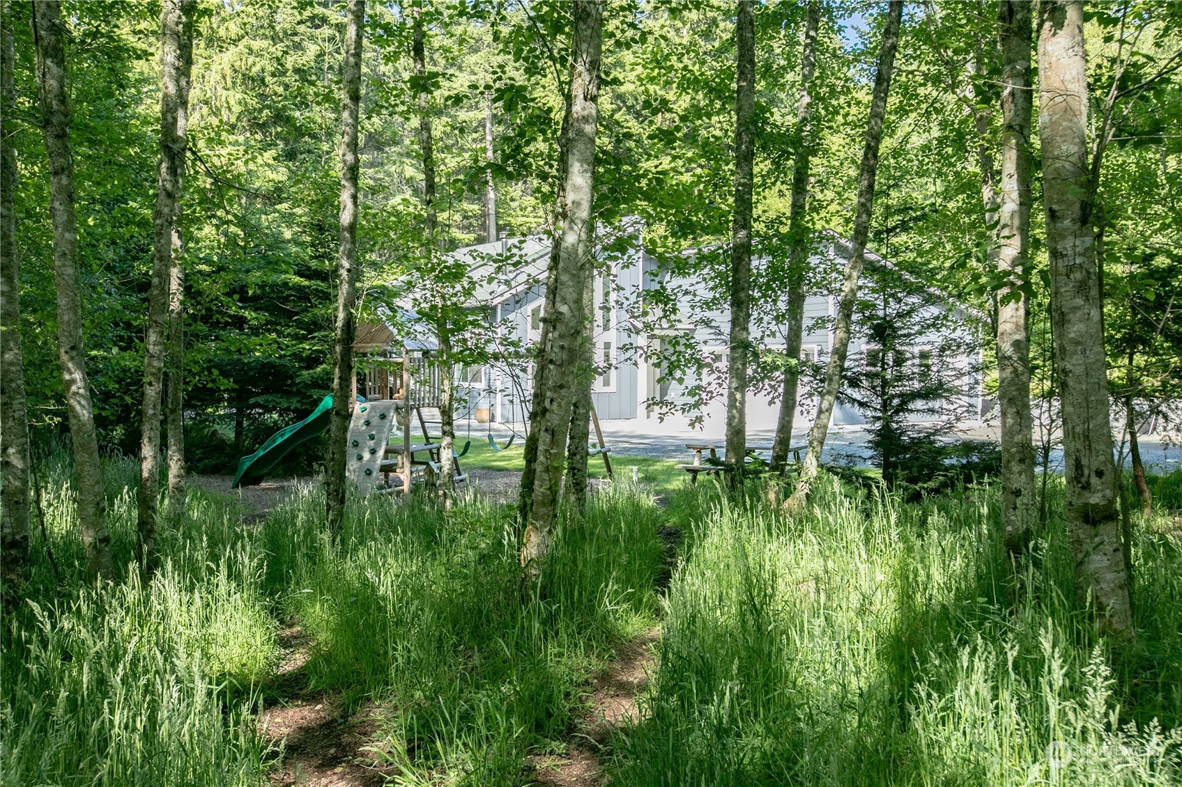 3867 East Harbor Road Langley, WA 98260 - Photo 35 of 39 a backyard of a house with lots of green space and trees