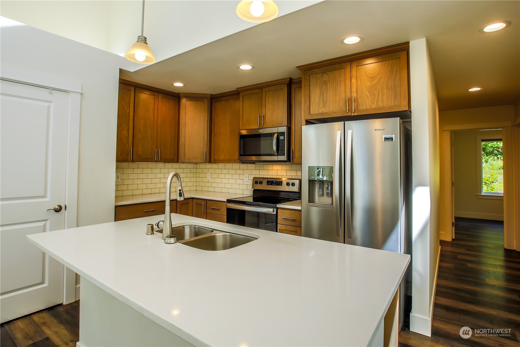 3867 East Harbor Road Langley, WA 98260 - Photo 5 of 39 a kitchen with granite countertop a sink a counter space stainless steel appliances cabinets and a counter top space