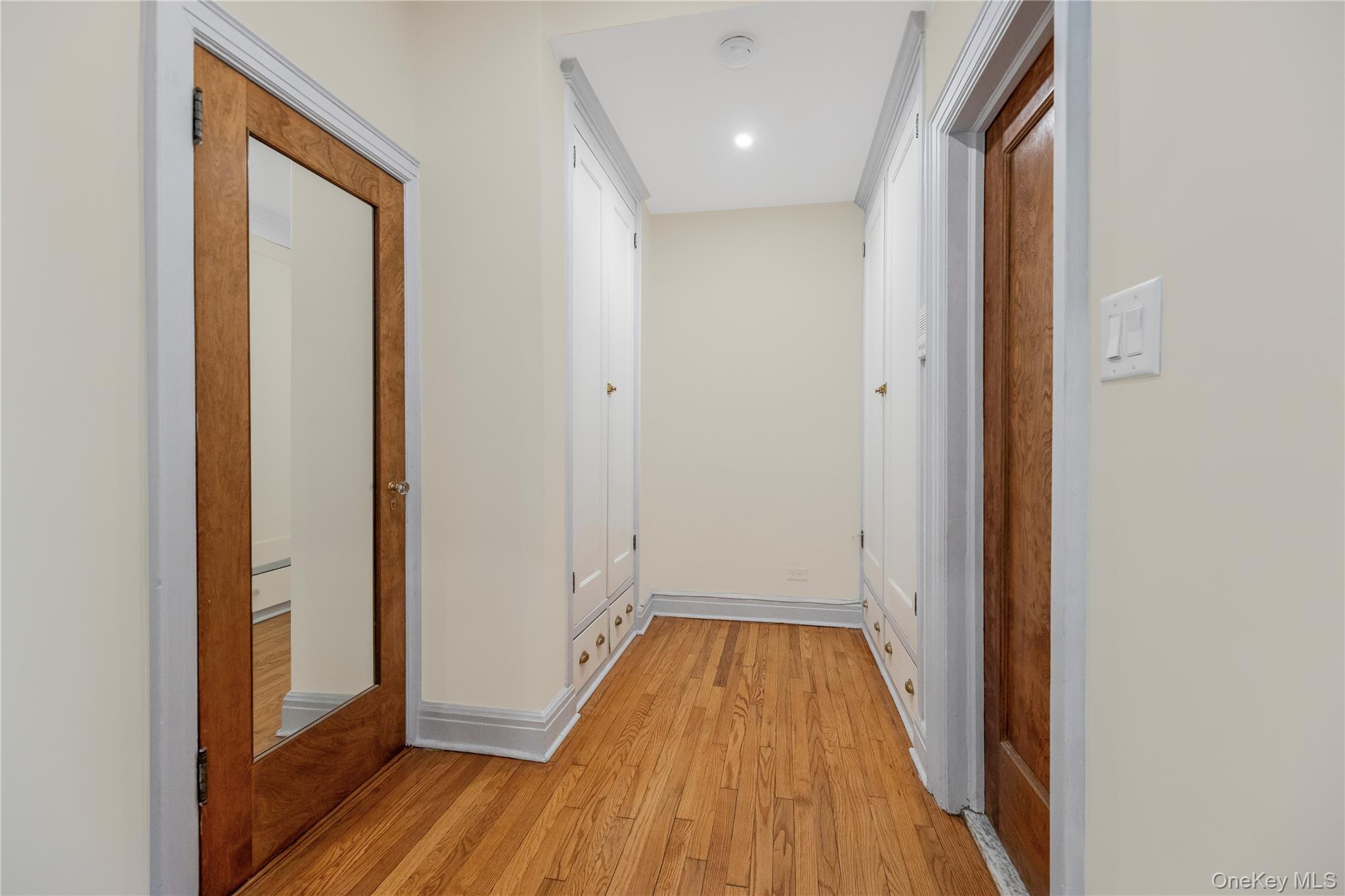 26 Pondfield Road, Unit 1D Bronxville, NY 10708 - Photo 14 of 21 a view of a hallway with wooden floor and staircase