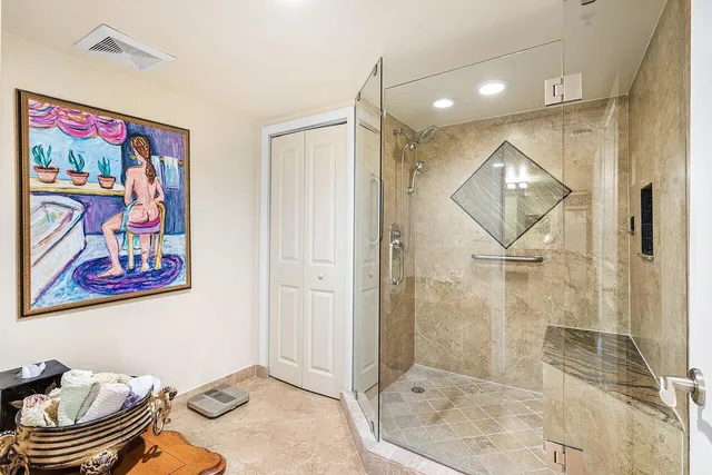 a bathroom with a granite countertop sink mirror vanity and toilet