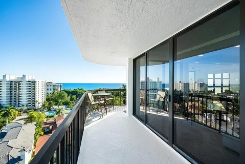 a balcony with furniture and city view