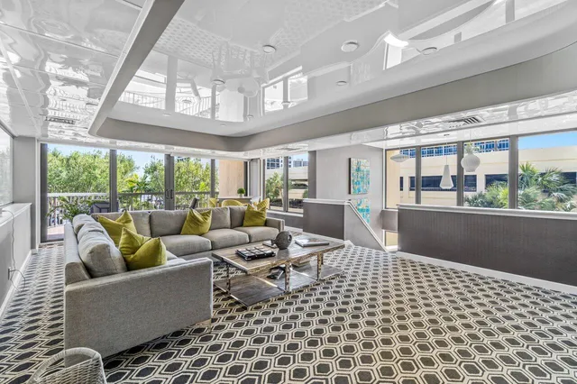 a living room with furniture and a floor to ceiling window