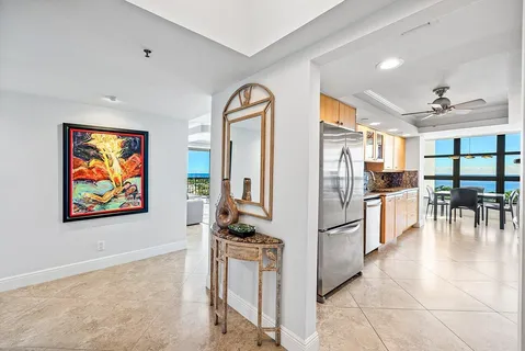 a kitchen with stainless steel appliances granite countertop a refrigerator and a stove top oven