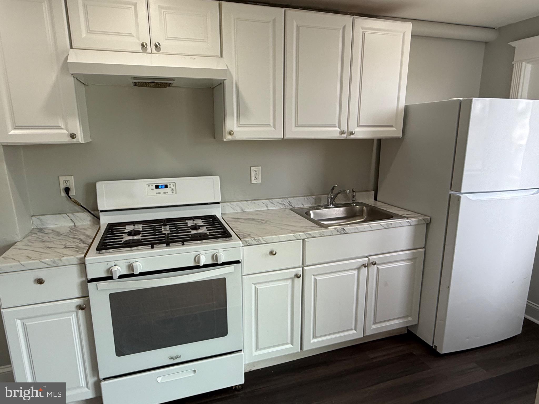 607 Littlecroft Road Upper Darby, PA 19082 - Photo 11 of 34 a kitchen with a stove cabinets and wooden floor