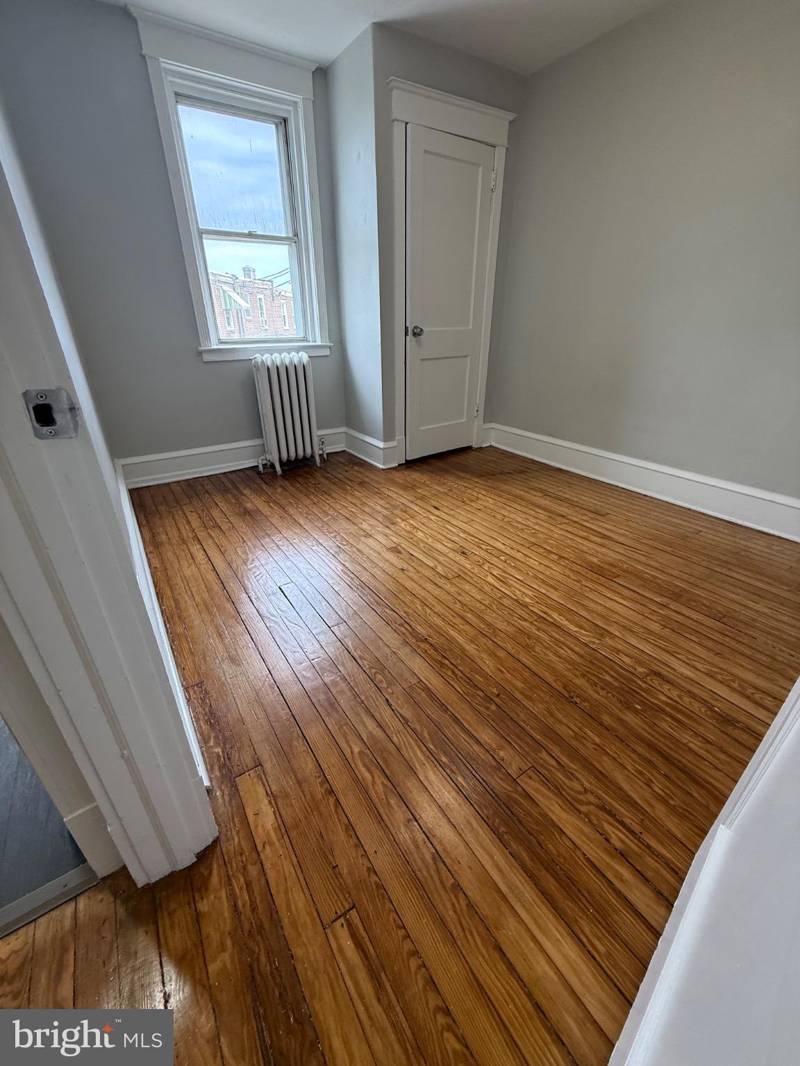 607 Littlecroft Road Upper Darby, PA 19082 - Photo 14 of 34 a view of an empty room with wooden floor and a window