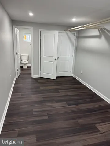 a view of a room with wooden floor and white walls