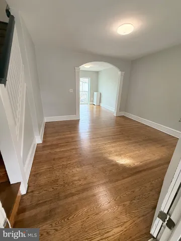 a view of a room with wooden floor