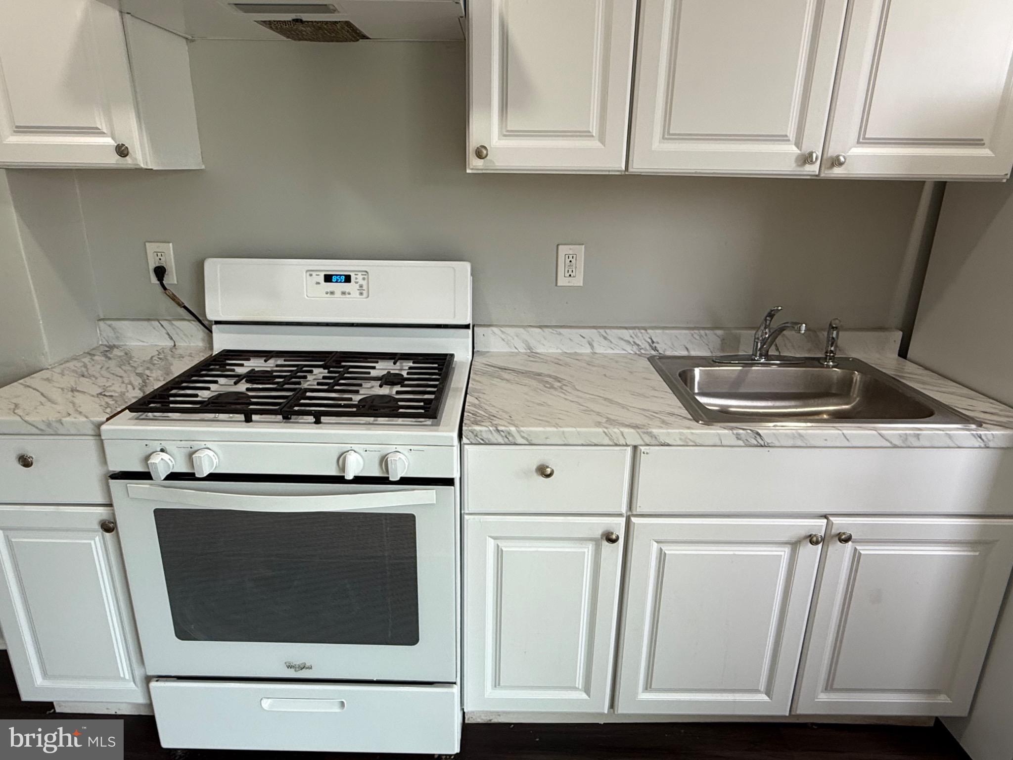 607 Littlecroft Road Upper Darby, PA 19082 - Photo 9 of 34 a kitchen with granite countertop white cabinets and a stove
