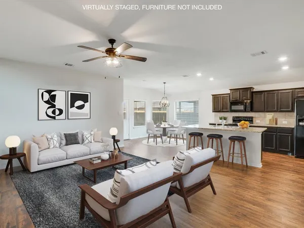 a living room with fireplace furniture and a wooden floor