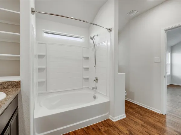 a bathroom with a bathtub and a shower