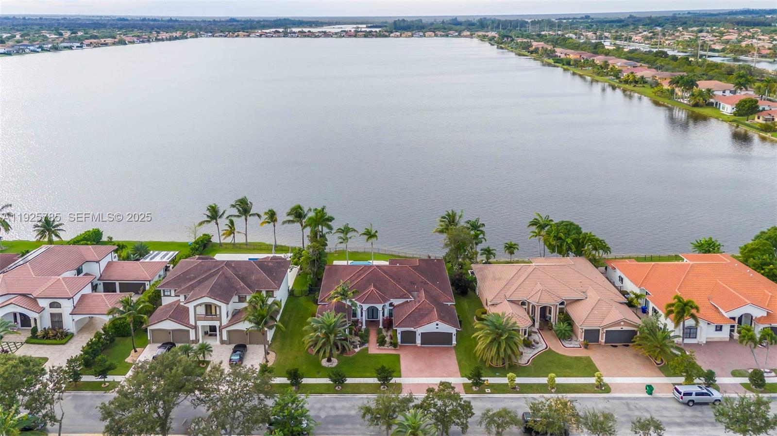 an aerial view of house with outdoor space and lake view