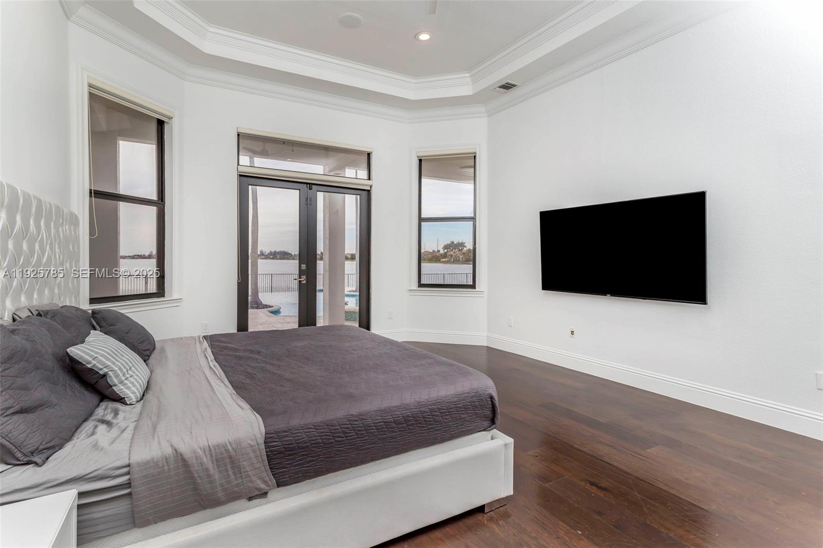 1962 Southwest 185th Avenue Miramar, FL 33029 - Photo 24 of 55 a bedroom with a large bed and a flat screen tv