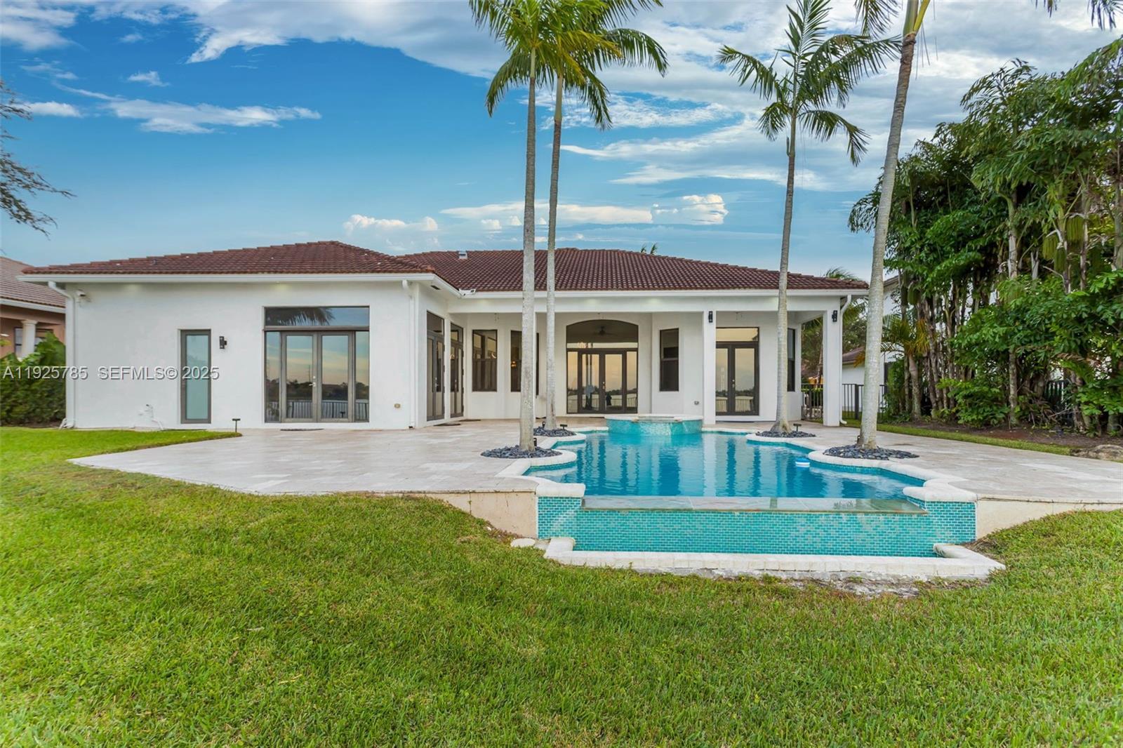1962 Southwest 185th Avenue Miramar, FL 33029 - Photo 40 of 55 a front view of a house with swimming pool having outdoor seating